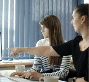 Two women looking at a computer screen